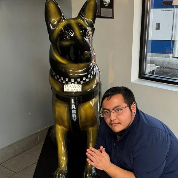 Larry posing with german shepherd statue