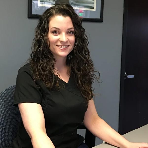 Rachel smiling while sitting at front desk