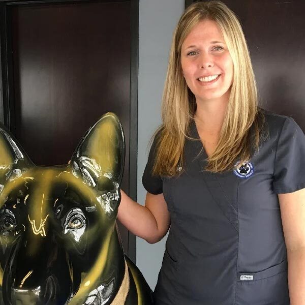 Jackie posing with german shepherd statue